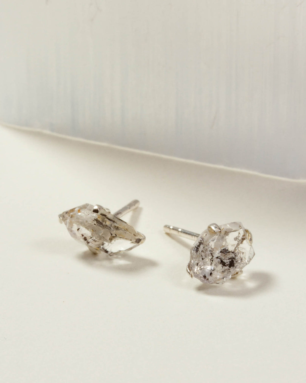 Herkimer Quartz Raw Beauty Birthstone Post Earrings on a white tabletop