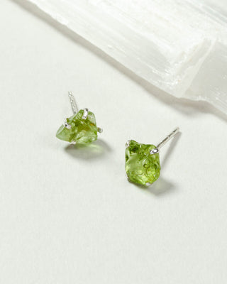 Peridot Raw Beauty Birthstone Post Earrings on a white tabletop