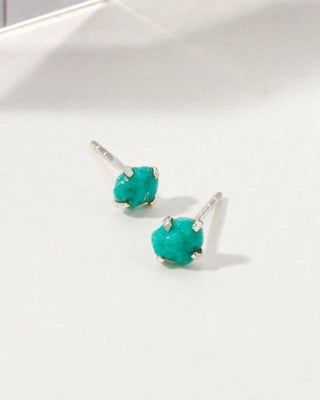 Turquoise Raw Beauty Birthstone Post Earrings on a white tabletop