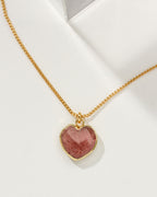 Strawberry quartz heart-shaped charm necklace on a white background.
