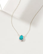 Necklace with a turquoise gemstone pendant and silver plated brass chain.