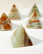 A group of banded, semi-translucent Wonder of the World Calcite Pyramids.