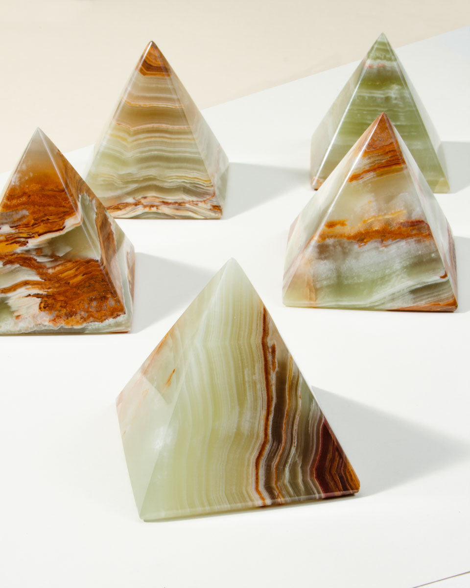 A group of banded, semi-translucent Wonder of the World Calcite Pyramids.